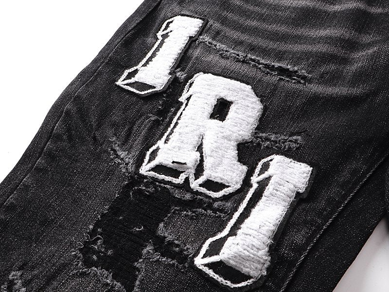 AMIRI Varsity Letter Appliqué Distressed Jeans — detail